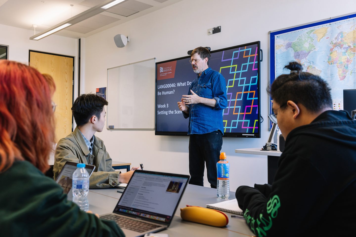 A teacher speaking in front of a class at the University of Bristol