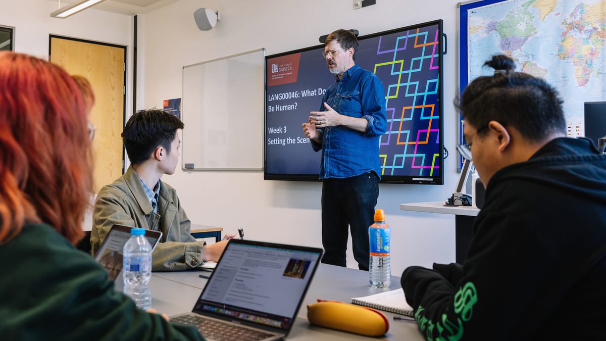 A teacher speaking in front of a class at the University of Bristol