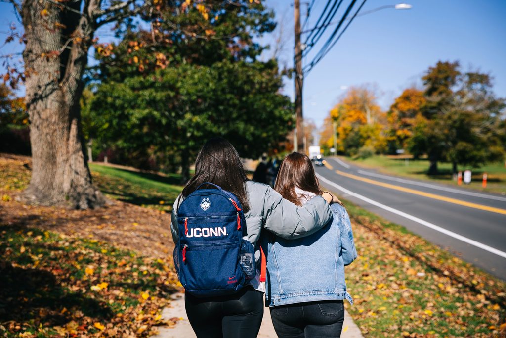Two students hugging and walking in Connecticut