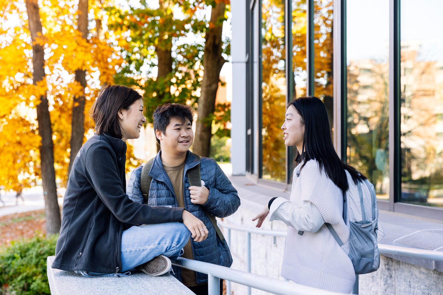 Three UCONN students chatting around the Storrs campus