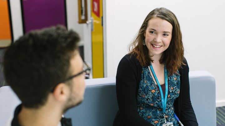 Student talking with a student services staff