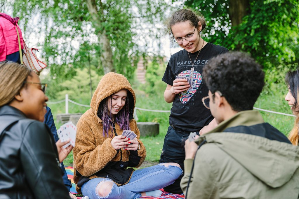 Students playing cards in the garden