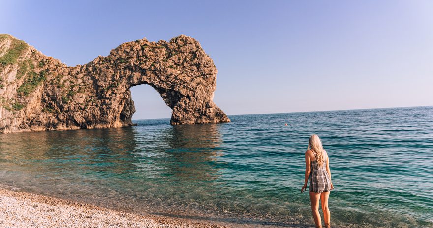 Student standing on the beach