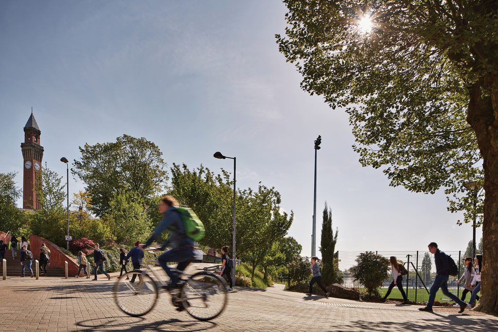Student cycling across campus