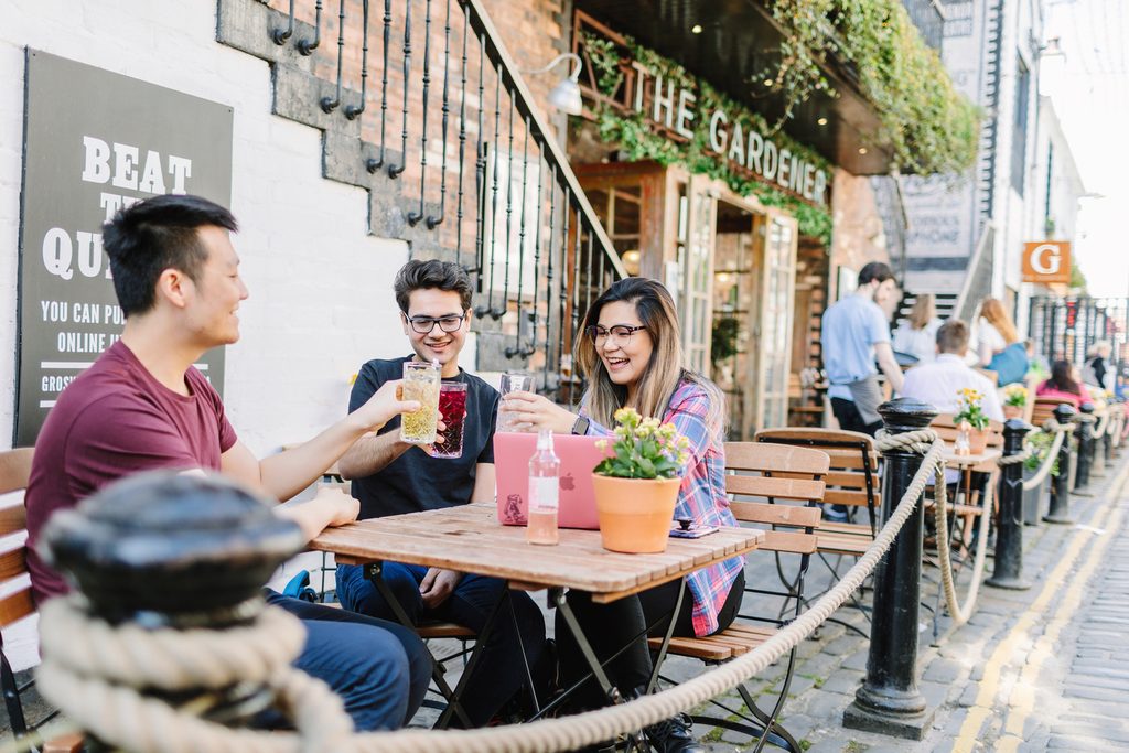 Students having drinks are having a good time outside