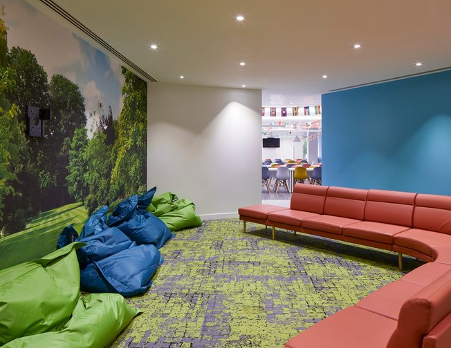 Shared area with a red couch and blue and gren bean bags