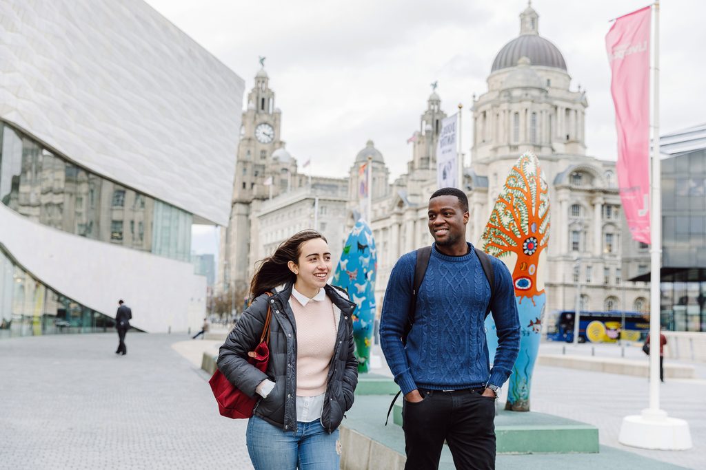 Two students walking by the Museum of Liverpool