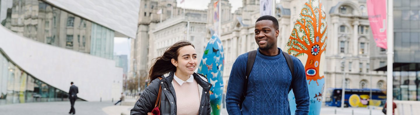 Two students walking by the Museum of Liverpool