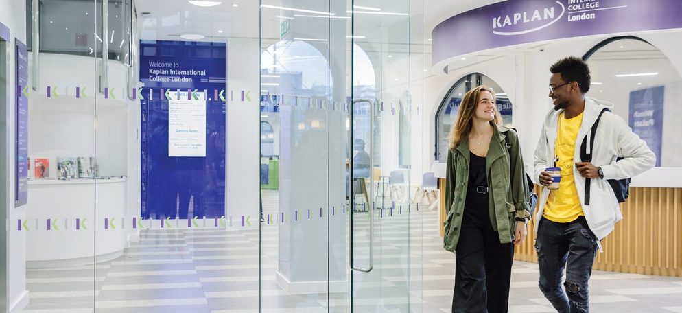 Two students exiting the college