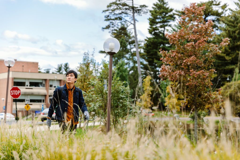 A Pace University student strolling around Westchester Campus