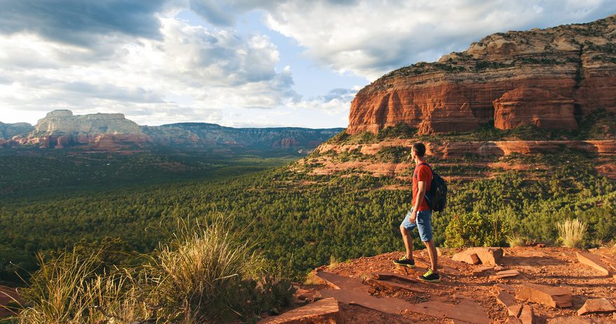 Student with a backpack watching the view at Red Rock State Park