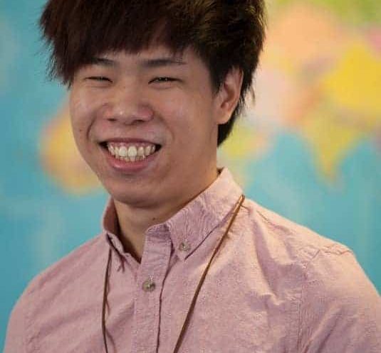 Ron a student from Hong Kong smiles