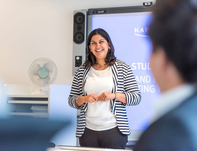 Sunita from Kaplan speaking at a meeting