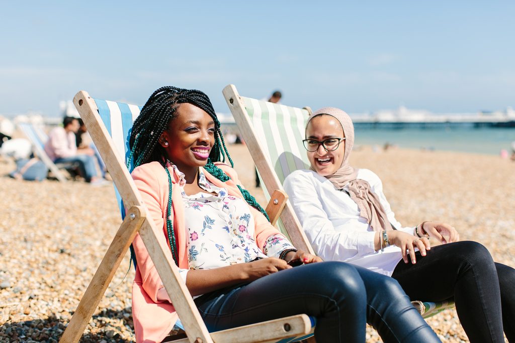 Two students enjoying the sun at the beach
