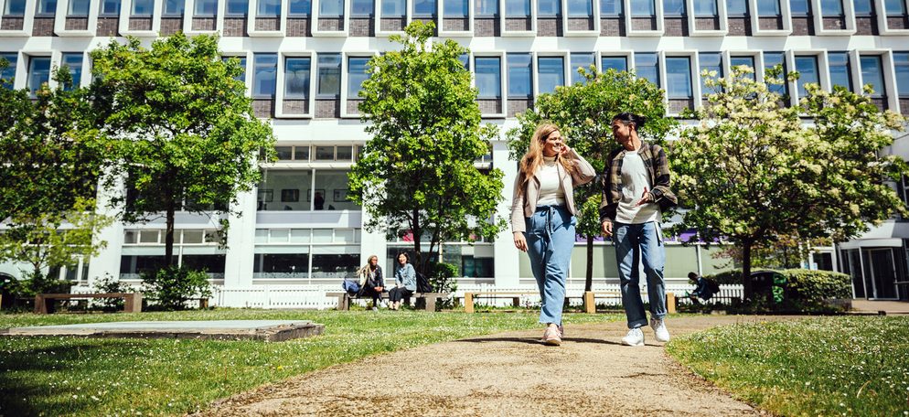 Two students walking in the campus garden