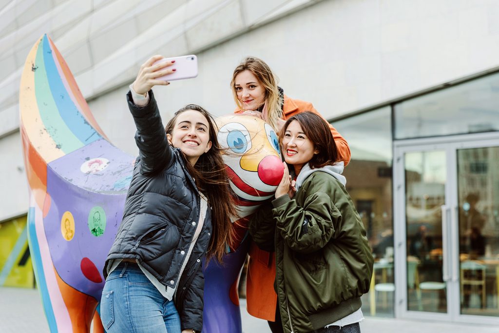 Liverpool College students taking a selfie with a statue