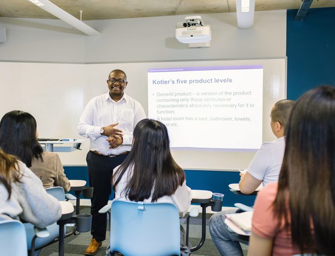 A teacher giving a lecture at UNIC