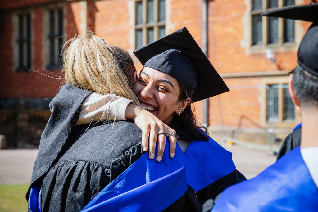 Students hugging on graduation day