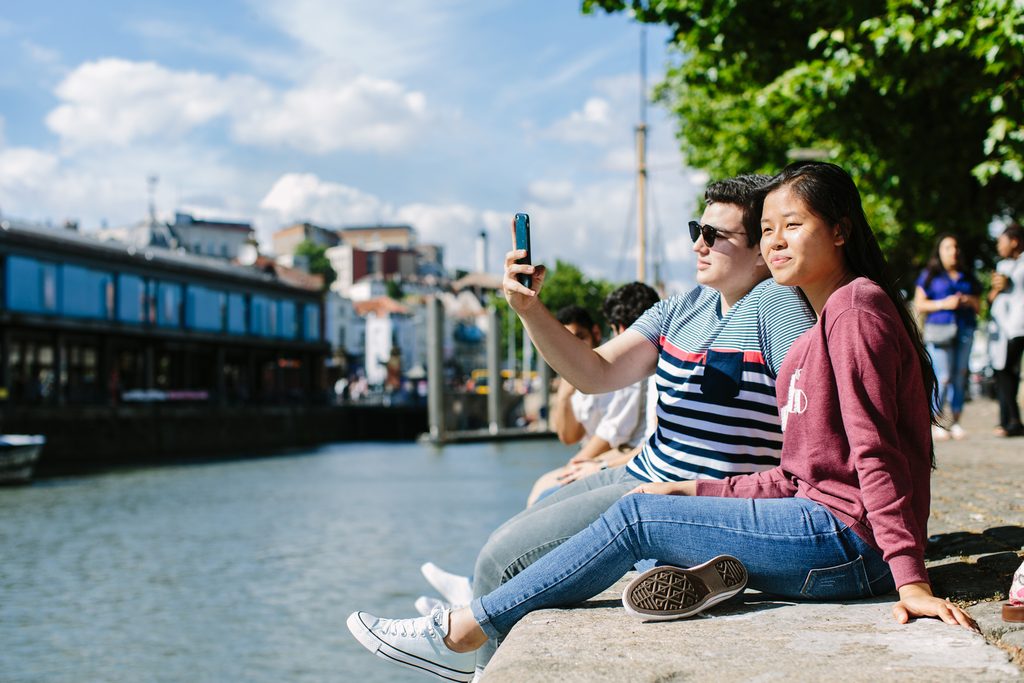 Students enjoying the sunny weather at the riverside