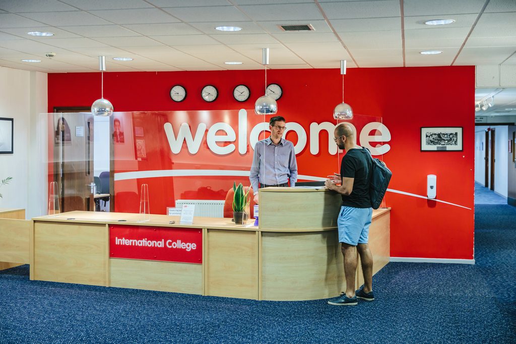 Student talking to student services at the welcome desk