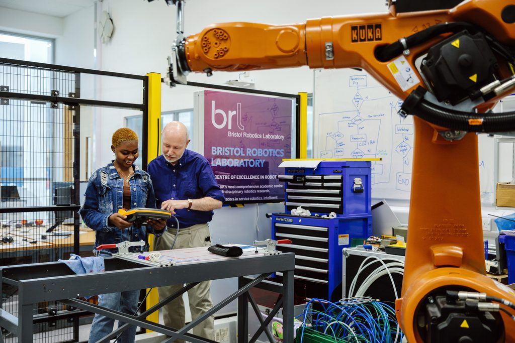 A UWEBIC student with a teacher in the robotics laboratory
