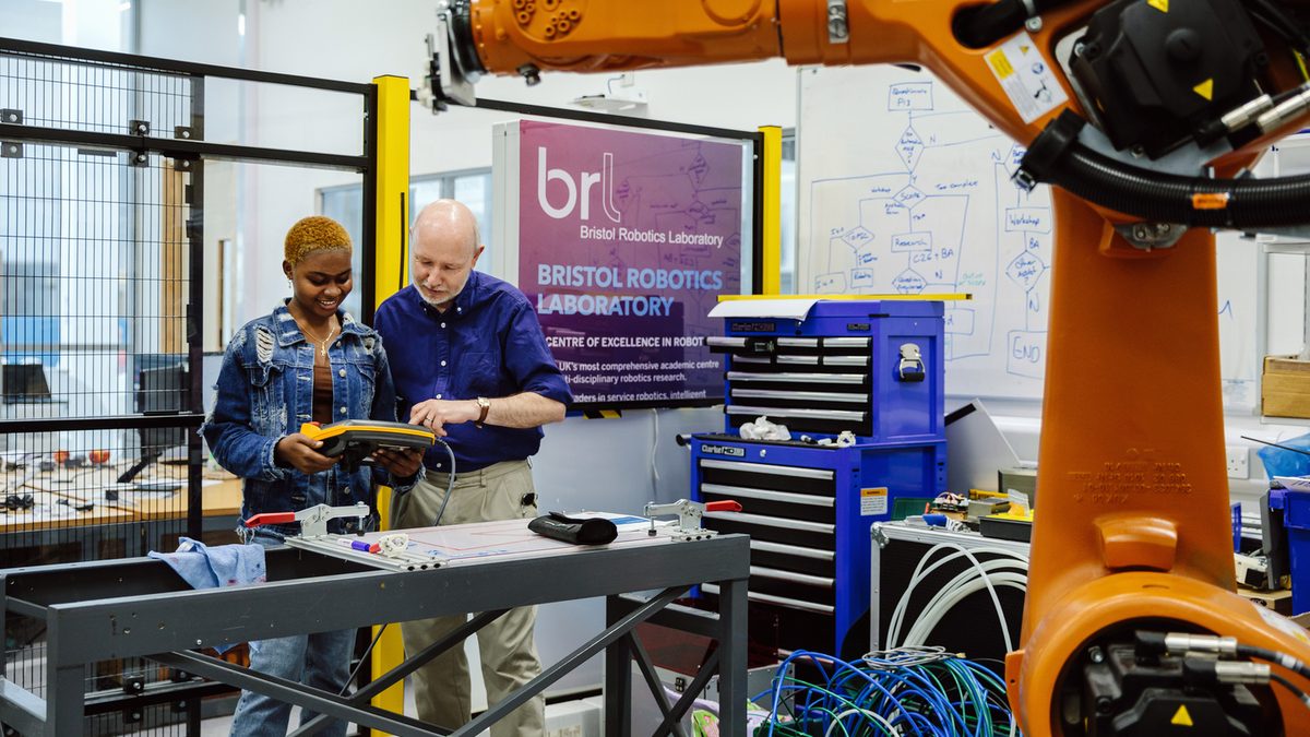 A UWEBIC student with a teacher in the robotics laboratory