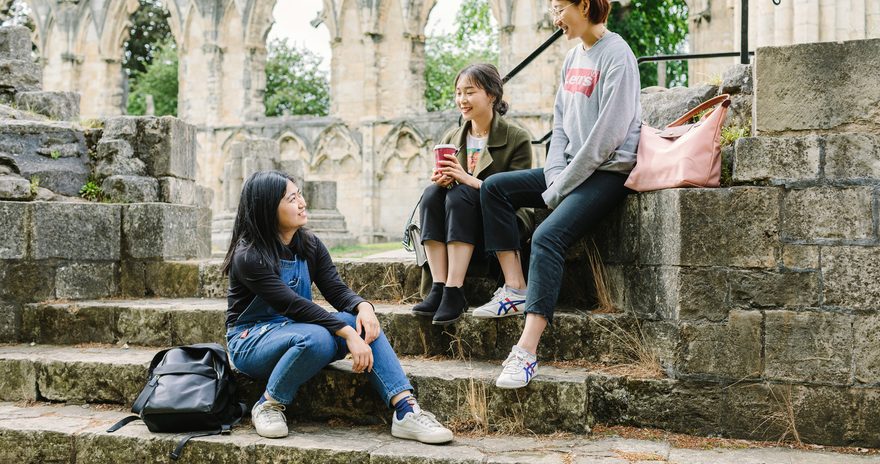 A group of students having a nice time at York Museum Gardens