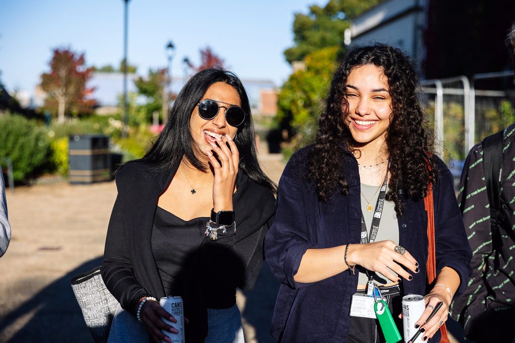 Two Bristol students walking and laughing