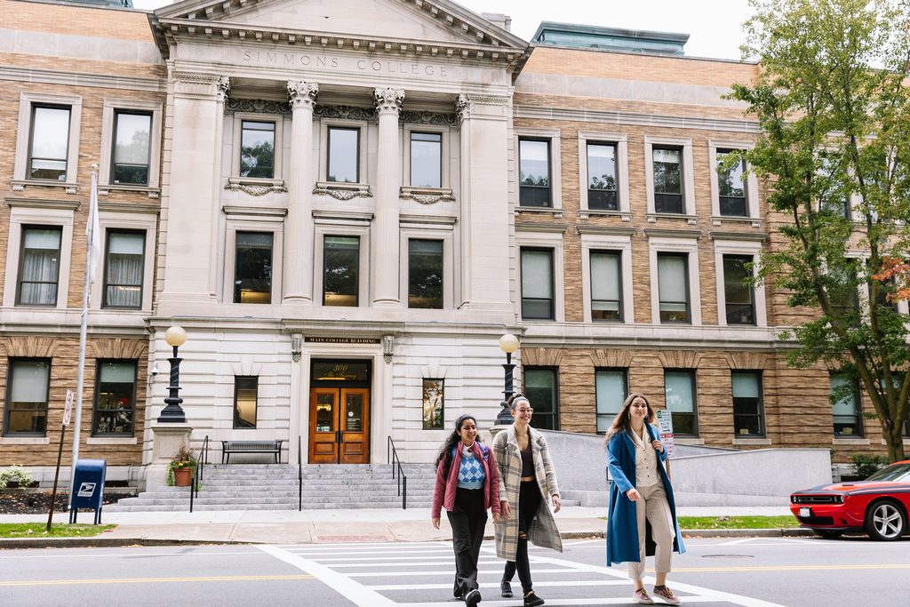 Simmons Students walking outside the college building