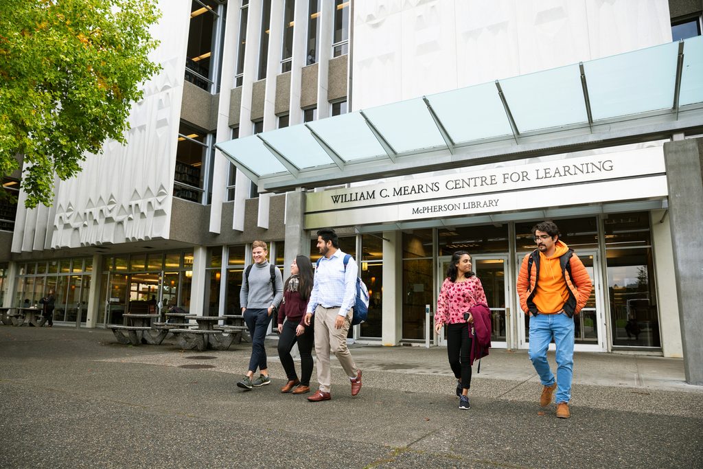 Students walking in front of the library.